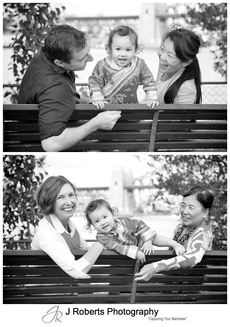 Baby girl on a bench with parents and grandmothers - sydney family portrait photography 